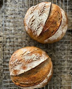 two loaves of bread sitting on top of a cooling rack