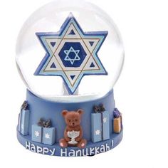 a snow globe with a teddy bear in front of it and the star of david on top