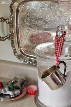 a glass jar filled with white liquid sitting on top of a counter next to other items