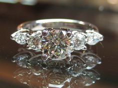 an engagement ring with three diamonds on it