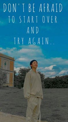 a man standing in front of a building with a quote on it that says, don't be afraid to start over and try again