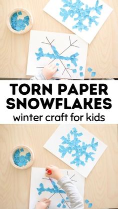 snowflakes made out of paper on top of a wooden table with blue paint