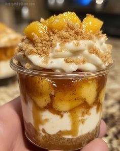 there is a dessert in the cup with toppings on top and crumbs all over it