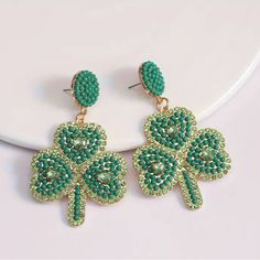 St. Patrick's Day Green Seed Bead Rhinestone Clover Dangle Earrings Cute Earrings Perfect For St. Patrick’s Day! These Are A Bit Heavy Because It’s Made Of Metal In Gold Tone. Green Seed Beads With Cute Faux Green Crystal Hearts. New Without Tags In Excellent Condition Dangle Beaded Earrings With Rhinestones As Gift, Jeweled Dangle Beaded Earrings For Party, Green Beaded Crystal Earrings, Jeweled Beaded Dangle Earrings For Gifts, Earrings Cute, Green Crystal, Green Crystals, Crystal Heart, Cute Earrings