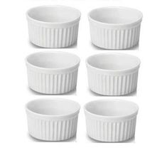 six white ramekin dishes sitting side by side