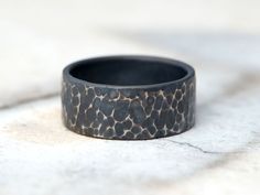 This is a beautiful Handcrafted Titanium Ring with a Dark hammered texture finish. A classic hammered texture is achieved using the rounded end of a ball-peen hammer.   Handcrafted by me from start to finish (no computerized machinery).  Details: *Listing is for 1 (one) Ring *I use a commercially pure (CP) grade of Titanium *Titanium is hypoallergenic so a great ring for those with skin allergies to common metals *Ring is solid but very light in the same time *Shipped in jewelry box, ready for g Rustic Wedding Band, Rustic Wedding Bands, Titanium Jewelry, Titanium Ring, Rugged Style, Skin Allergies, Ring Simple, Local Jewelry, Wide Rings