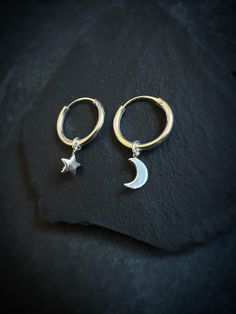 The Celestial Moon & Star hoop earrings will send your mind to outer space . These 1.5cm diameter infinity style hoops feature your choice of Moon and Star combinations. They are polished to a high shine so starlight can twinkle off of their surface. A reflection of the night sky, this celestial piece is made to be worn daily, truly a staple piece of jewelry. Let this piece highlight your own beauty with every! - 100% solid sterling silver 925  - Lead and Nickel free - Handmade one of a kind  Barter Babe By Sarah  Each unique piece is thoughtfully designed and hand crafted by Sarah in California. Each piece is one of a kind made in my one woman studio. Your handmade jewelry will be delivered in a re-usable cardboard black box. Celestial Small Hoop Jewelry With Star Charm, Celestial Hoop Earrings With Star Charm For Everyday, Celestial Small Hoop Earrings With Star Charm, Celestial Huggie Earrings With Moon Charm, Sterling Silver Celestial Earrings For Everyday, Celestial Star-shaped Hoop Earrings With Moon Charm, Celestial Small Hoop Huggie Earrings, Celestial Small Hoop Earrings For Everyday, Silver Crescent Earrings With Star Charm