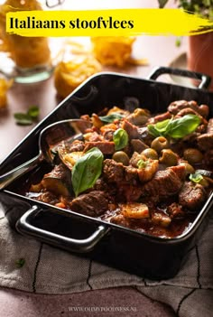 a casserole dish with meat and vegetables in it