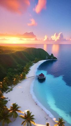 an aerial view of a beach with palm trees and a hut in the water at sunset