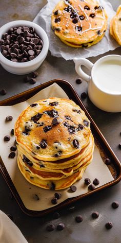 pancakes with chocolate chips and milk on a tray