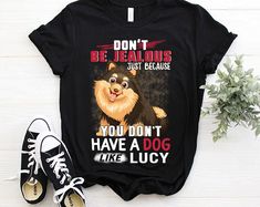 a black shirt with a dog saying don't be jealous just because you don't have a dog like lucky