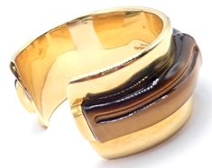 About This Piece: Metal: 18k yellow gold Length: 7" Weight: 87.4 grams Width: 1 1/4" Hallmarks: 2002 Tiffany & Co 750 Hong Kong T3329ladd Designer Gold Hallmarked Bangle, Designer Gold Bangle Hallmarked, Gold Modernist Cuff Bracelet For Formal Occasions, Designer Gold Bangle With Polished Finish, Designer Gold Cuff Bracelet With Polished Finish, Designer Gold Cuff Bracelet, Designer Adjustable Yellow Gold Cuff Bracelet, Designer Polished Finish Cuff Bracelet As Gift, Designer Polished Cuff Bracelet Gift