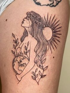 a woman with long hair and flowers on her thigh is depicted in this tattoo design