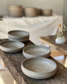 three bowls sitting on top of a wooden table