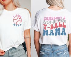 "⚾ This vibrant shirt is sure to turn heads with its bold and cheeky statement proudly displayed on the back. The eye-catching design features the words \"Somebody's Loud Mouth T-Ball Mama\" in a playful font, making it clear that the wearer is not afraid to speak their mind. And whether you're cheering on your child at their next t-ball game or simply running errands around town, this shirt is the perfect way to show off your proud mama status. So why settle for a plain, boring shirt when you can make a statement with this eye-catching and fun design? Get your hands on this shirt today and show the world that you're a t-ball mama who's proud to be loud! 👕 PRODUCT INFO The Bella + Canvas shirts are super soft and comfy! These t-shirts are made of light fabric and have ribbed knit collars Tball Mom Outfits, White Tops With Funny Text For Fans, Fun White Tops For Game Day, Team Spirit Tops With Funny Text For Sports Events, Team Spirit Tops For Sports Events With Funny Text, Fun Graphic Print T-shirt For Sports Events, Short Sleeve Tops With Funny Text For Sports Events, Cotton Tops With Funny Text For Sports Events, Funny Text Short Sleeve Tops For Sports Events