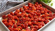 a pan filled with cooked tomatoes on top of a table