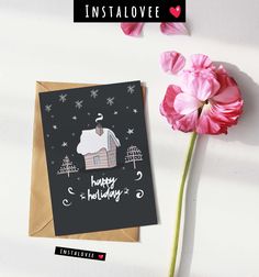 there is a card that says happy holidays with a house on it and pink flowers next to it