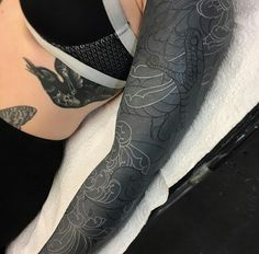 a woman's leg with tattoos on it