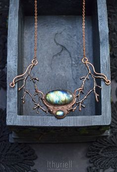 "Elaborate faerie necklace in a shape of copper branches embracing blue labradorite that reminds of will-o'-the-wisps and faerie lights. A tiny wearable fairy tale to adorn your neck and bring a bit of very special magic to your everyday look. Far in the wilderness, the lights are dancing in small circles on a moonless night. It's a sight to behold, but the true beauty of the dance can only be seen from above. If one were to fly up in the sky and look down upon the marshes, they would see that t Mystical Hand Forged Copper Necklaces, Mystical Hand Forged Copper Necklace, Mystical Hand Forged Labradorite Necklace, Faery Jewelry, Wrap Choker Necklace, Moonless Night, Handmade Choker Necklace, Forest Necklace, Tanzanite Pendant