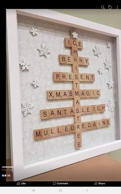 a wooden scrabble christmas tree in a white frame