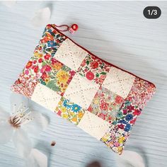 a patchwork purse with flowers on it