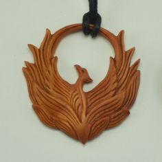 Hand Carved Sabo Wood Holy Phoenix Pendant With Adjustable Necklace Cord To Fit All Sizes. Approximately 1.7" Length By 1.5" Width. Return To Tiffany Necklace, Fantasy Pendant, Faux Gauges, Gold Leaf Pendant, Phoenix Necklace, Phoenix Pendant, Turquoise Statement Necklace, Wood Carving Designs, Flower Ear