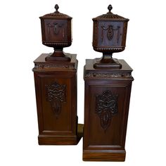 two wooden urns sitting next to each other on top of a white background,