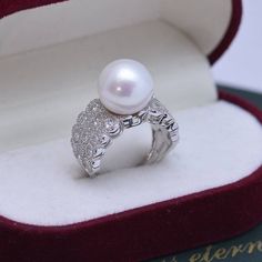 Looking for a timeless piece of pearl jewelry to add to your collection? House of Pearls’ 12-13mm Freshwater Pearl & Large Full CZ Wide Diamond Ring is the perfect classic addition. This ring offers a large 12-13mm freshwater pearl alongside a large full CZ diamond, making it wearable luxury. Celebrate your special moments by wearing this beautiful pearl & diamond ring. White 12-13mm Freshwater Pearl Ring This popular ring design features AAAA quality, round freshwater pearls measuring 12-13mm. Wide Diamond Rings, Pearl Diamond Ring, Popular Rings, Freshwater Pearl Ring, Pearl Rings, Pearl And Diamond Ring, Pearl Necklace Earrings, Purple Pearl, Wide Ring