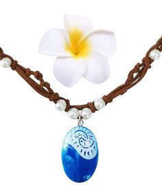 a necklace with a white flower and blue pendant