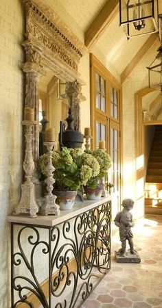 an iron railing with vases and flowers on it in front of a door way