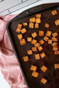 tofu cubes on a baking sheet ready to be cooked in the oven for dinner