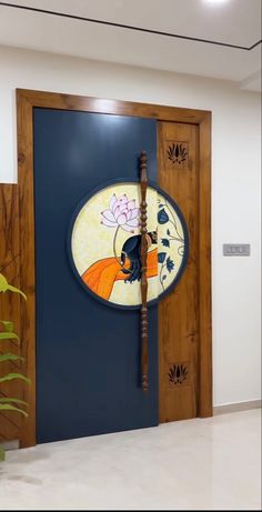 a blue door with a painting on the side and a stick sticking out of it