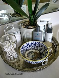 a bathroom sink filled with lots of clutter