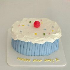 a blue and white frosted birthday cake with sprinkles on the top