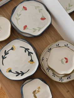 several plates with designs on them sitting on a table