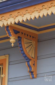 an orange and blue building with a clock on it's side window sill