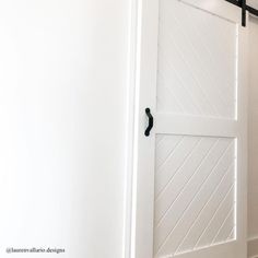 an open white door with black hardware on it