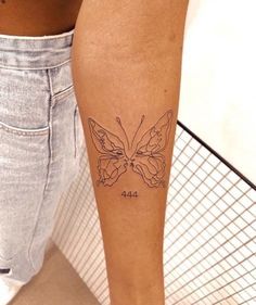 a woman's leg with a butterfly tattoo on the left side of her calf