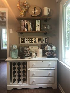 there is a coffee and wine sign on the wall in this living room with two shelves above it