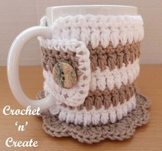 a crocheted coffee cup with a button on it