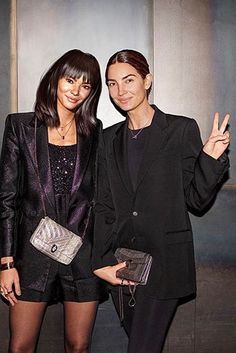 two women standing next to each other posing for the camera