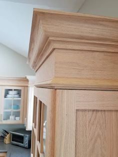 the kitchen cabinets are made of wood and have been painted in light brown with white trim