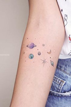 a woman's arm with planets and stars on the left side of her arm