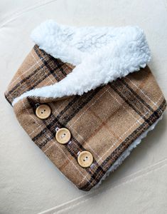 a close up of a piece of cloth with buttons on it and a white hat