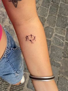 two people with matching tattoos on their arms