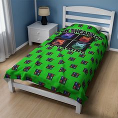 a bed in a room with a green bedspread that has pictures on it