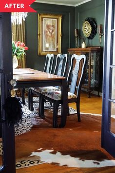 a dining room table with chairs and a cowhide rug on the floor in front of it