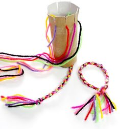 a paper cup filled with multi colored string