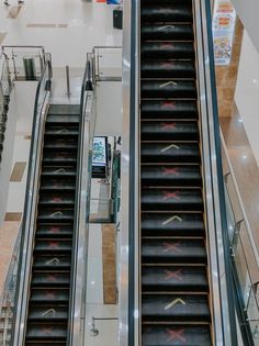 two escalators with arrows painted on them