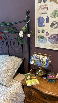 a bedroom with a bed, lamp and pictures on the wall